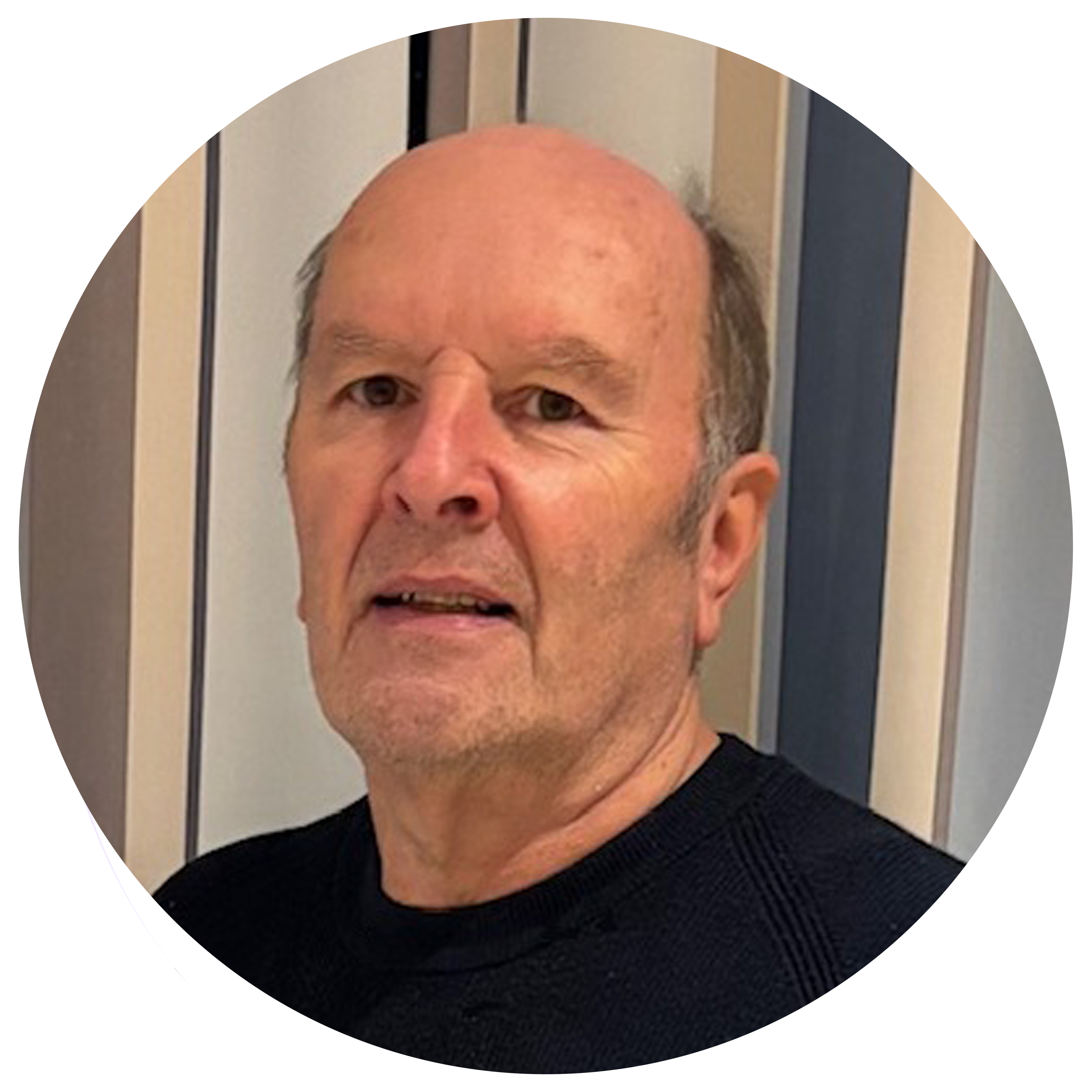 image of a man sitting in a room, smiling